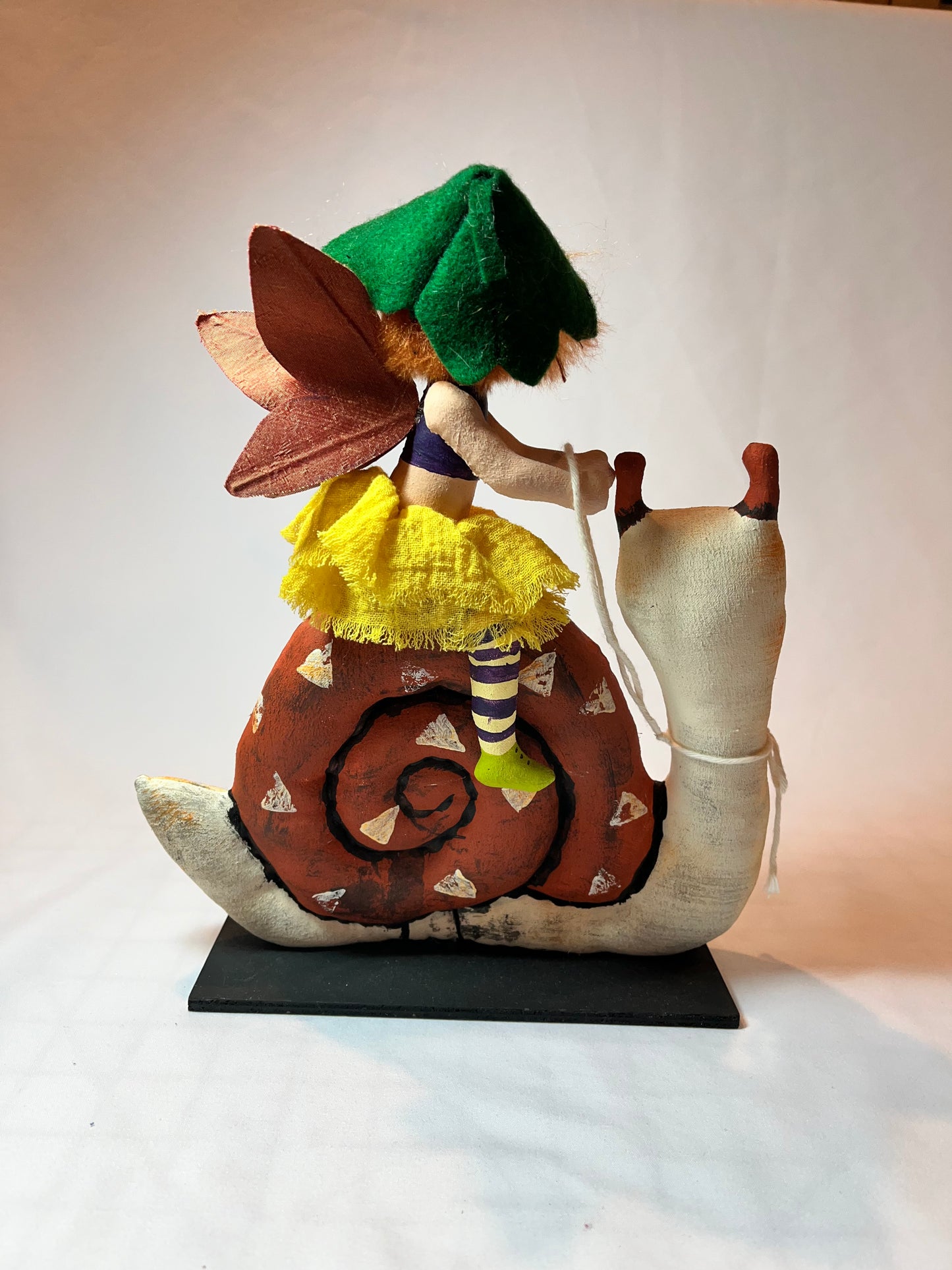 Art doll. Folk art style. Snail rider.