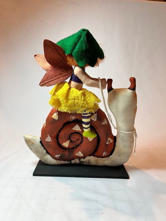 Art doll. Folk art style. Snail rider.