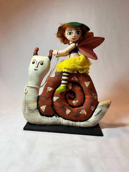 Art doll. Folk art style. Snail rider.